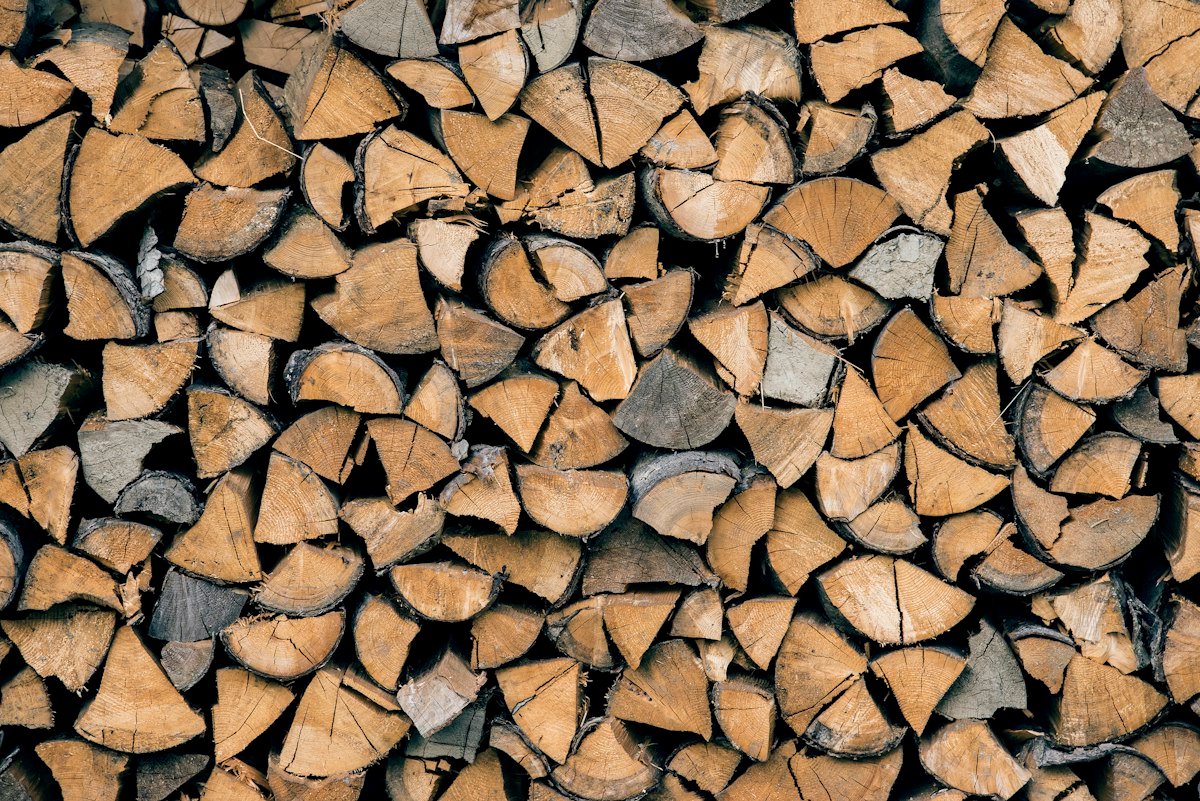 Bûches de bois de chauffage fendues et empilées en rangs serrés